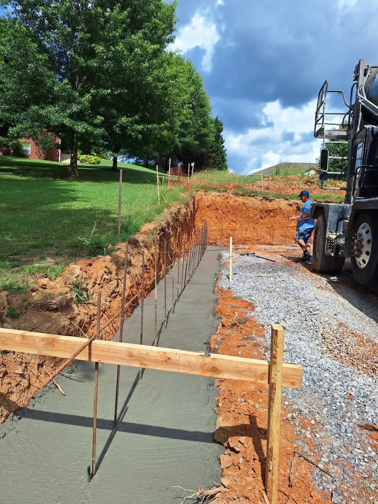Zeledon Concrete pouring footings from the mixer on a Knoxville, Tennessee job site