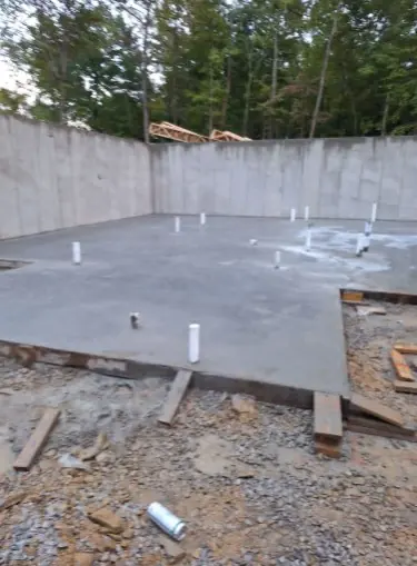 Foundation slab poured around the plumbing stub-outs in Knoxville, Tennessee