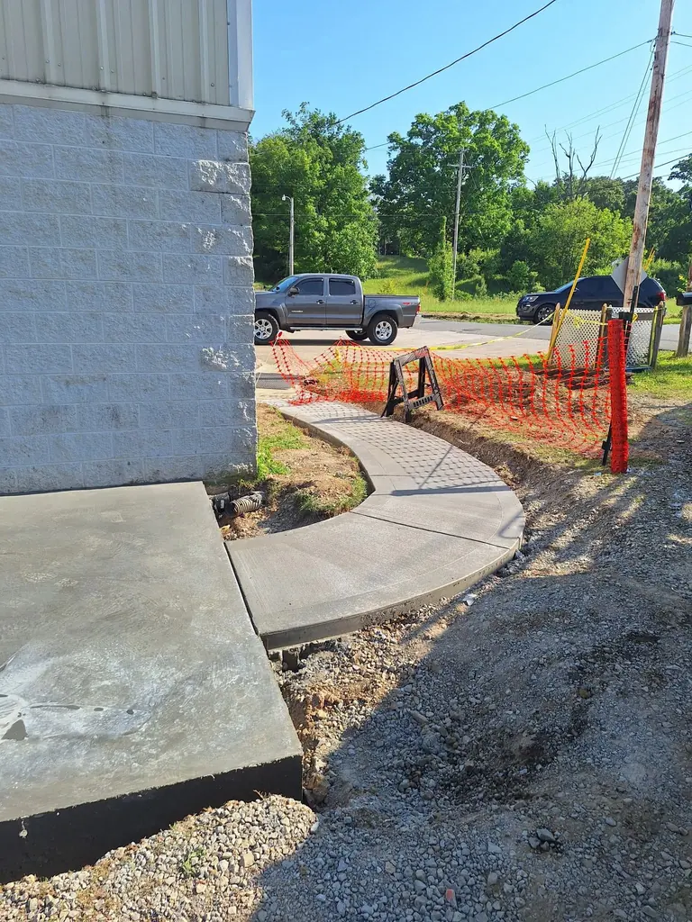 New sidewalk poured beside a block building in Knoxville, Tennessee