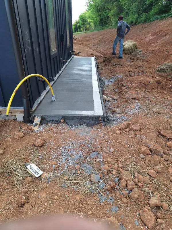 Concrete walkway poured along the side of a metal building near Knoxville, Tennessee